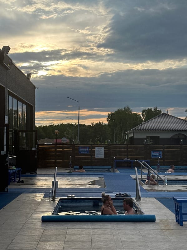 Relaxing at a Kamchatka hot spring with a volcano backdrop