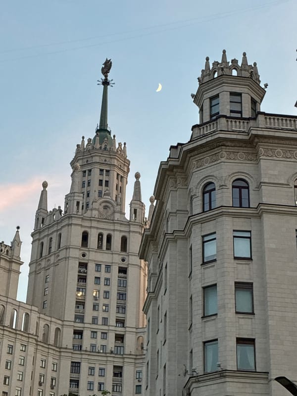 Evening cityscape documentation in Ukrainian settlement captures architecture, moon