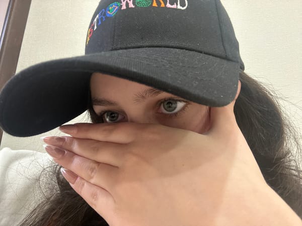 Person in Astroworld cap relaxes in Yerevan bedroom