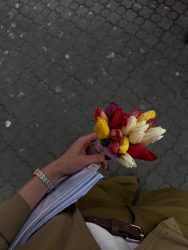 Visitor documents afternoon at Yerevan Cascade with flowers