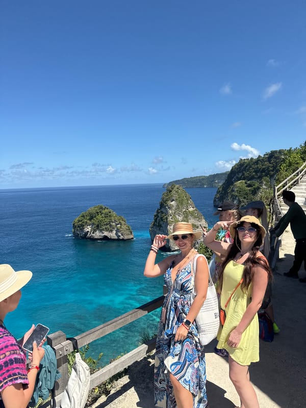 Four women pose at scenic Nusa Penida cliff viewpoint