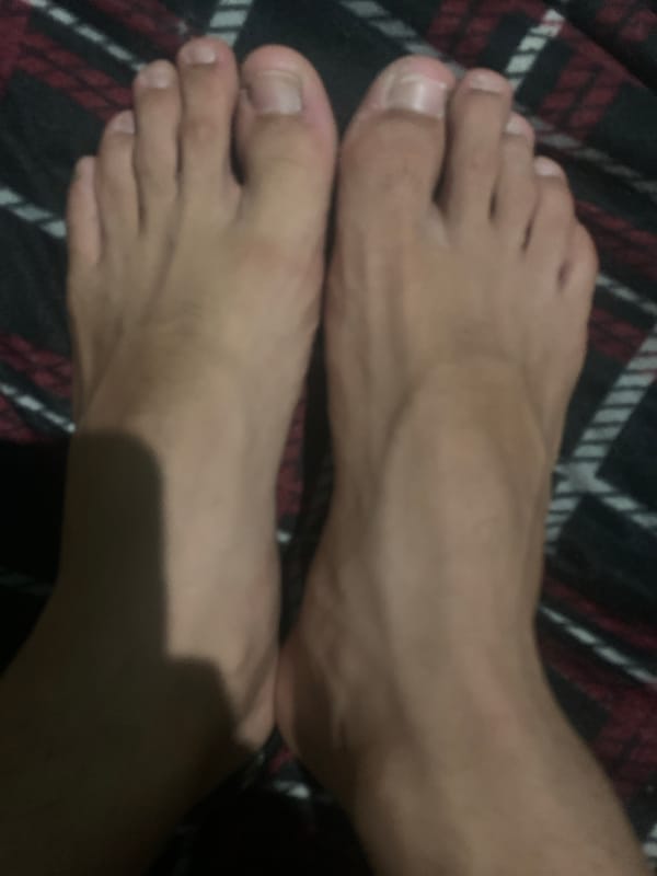 Feet photographed resting on patterned cloth in Venezuela