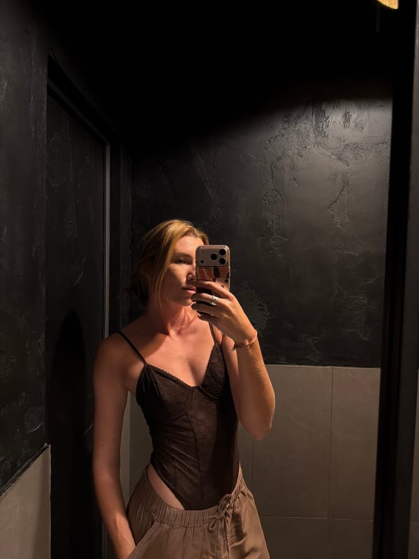 Woman takes bathroom mirror selfie in Bishkek