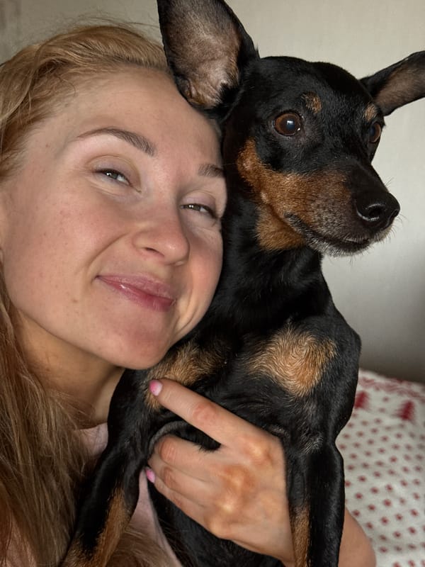Woman plays with dachshund dog in early morning Perm