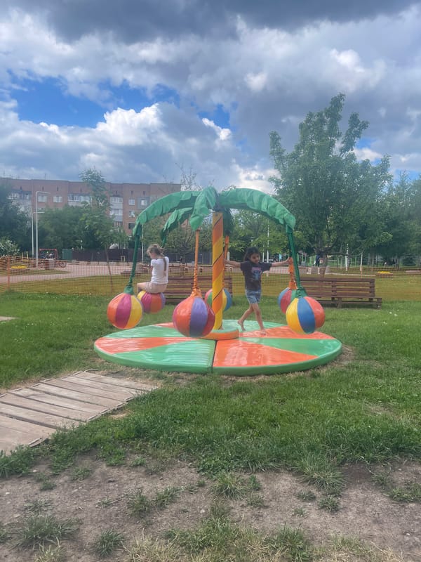 Children play at jungle-themed playground as pigeon forages nearby