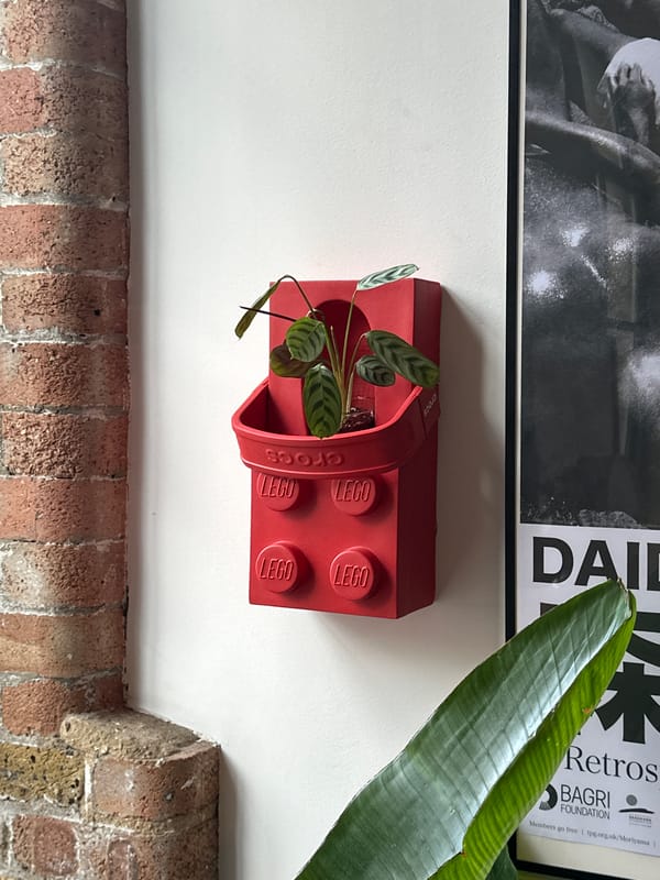 Red Lego Croc-shaped planter spotted on London wall