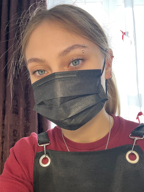 Young person with piercings photographed in selfie shots