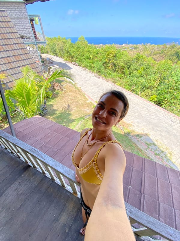 Selfies and paragliders on a Bali coastal deck