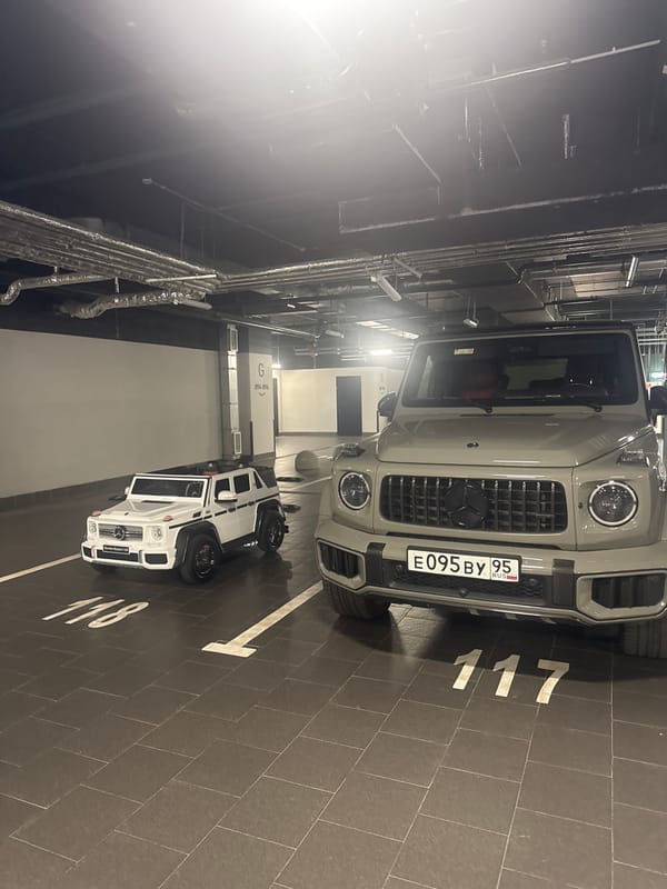Full-size and toy G-Wagon parked side by side in Moscow garage