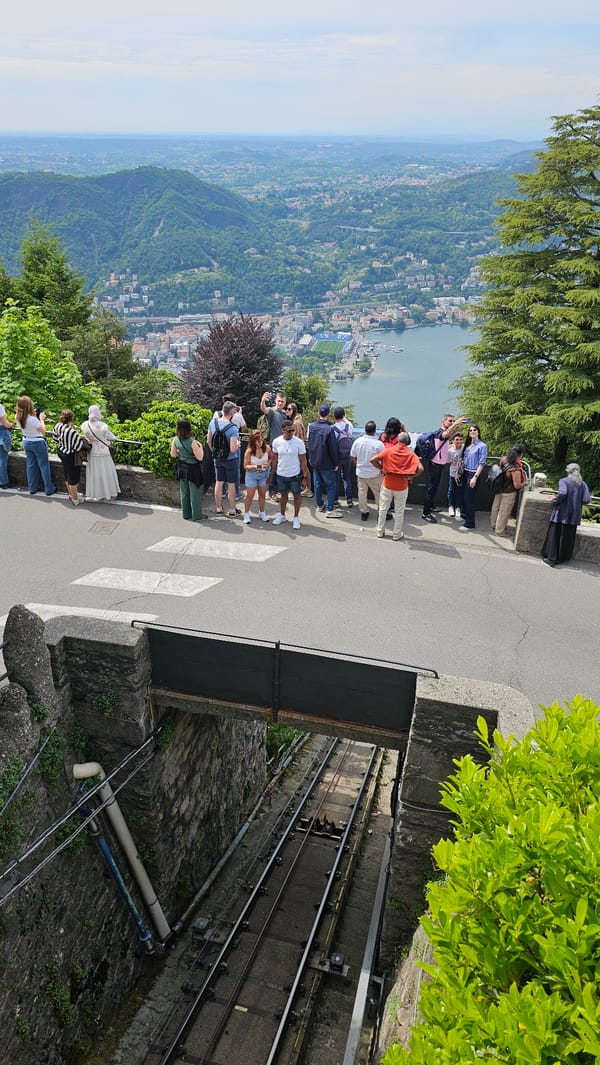Tourists gather at scenic Brunate overlooks viewing Italian lake vistas