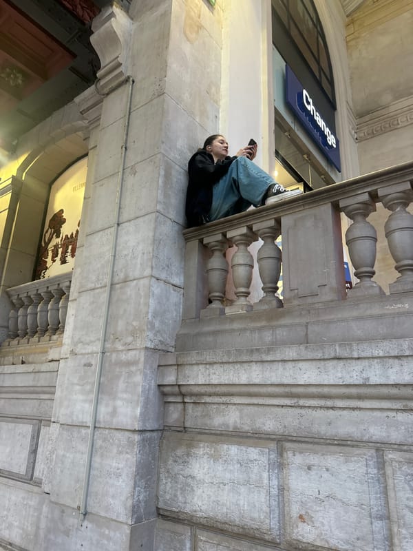 Person sits on stone ledge in Paris
