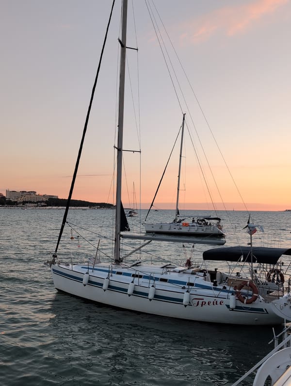 Sunset harbor scene in Gelendzhik with docked boats and promenade