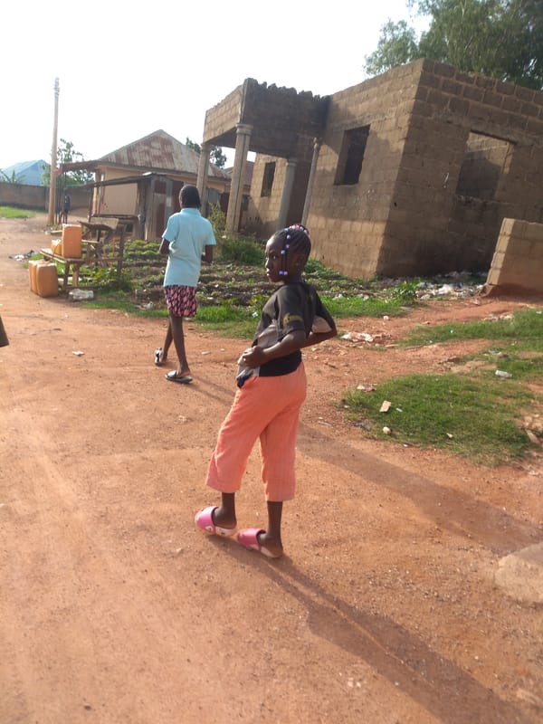Daily life unfolds in Jos, Nigeria neighborhood streets