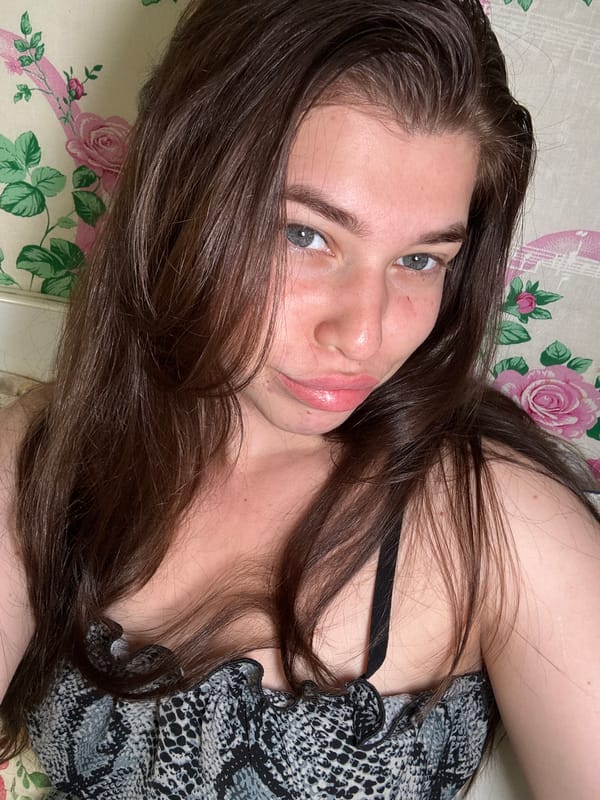 Woman rests on floral bedding in Мещёры, Russia