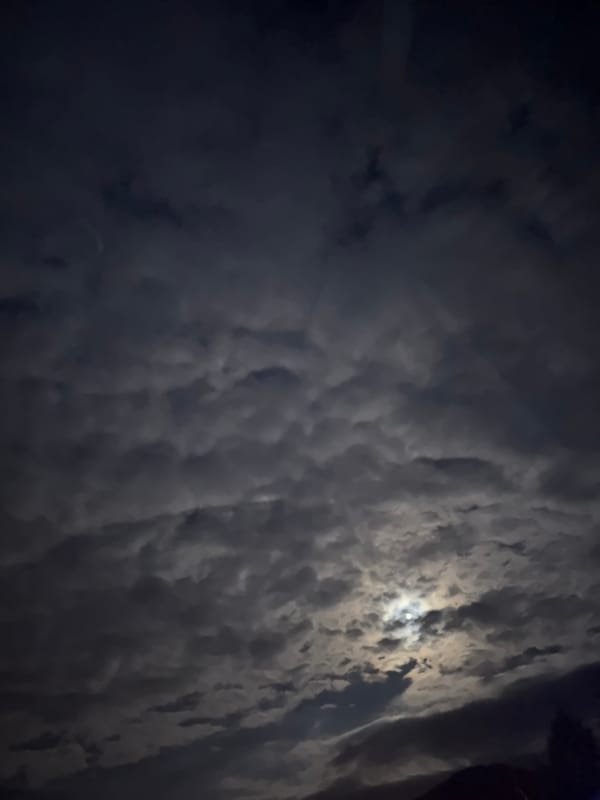 Moon breaks through heavy clouds over Vrachesh, Bulgaria