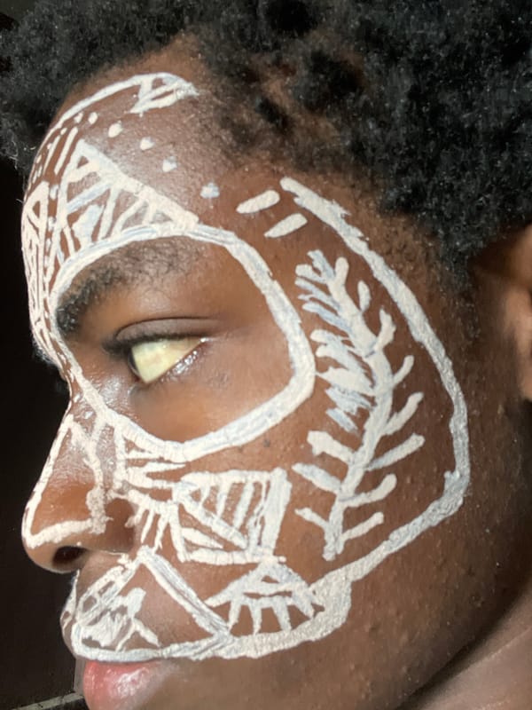 Man with tribal face paint photographed in Nkpor, Nigeria