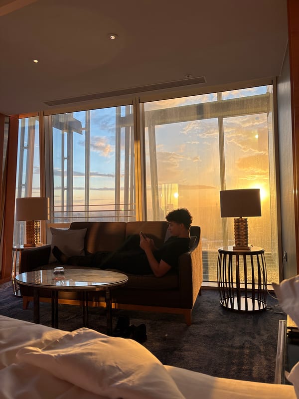 Man enjoys sunset in modern London hotel suite
