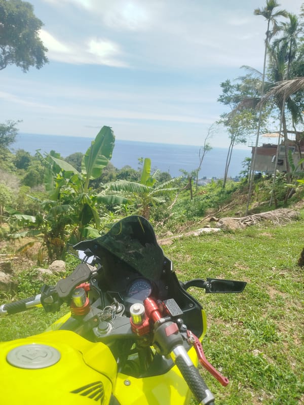 Parked motorcycle, ocean views from a Karon hillside