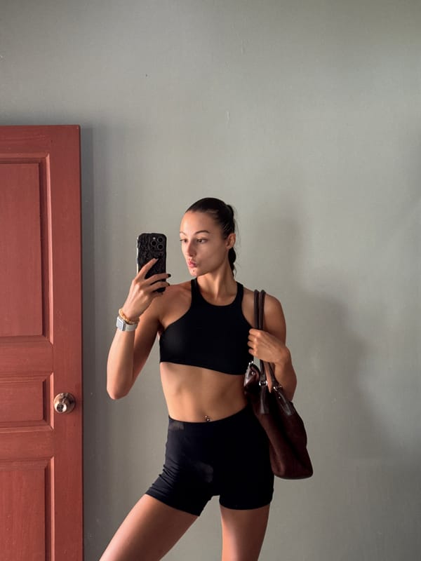 Woman Takes Mirror Selfies in Black Workout Gear in Thailand