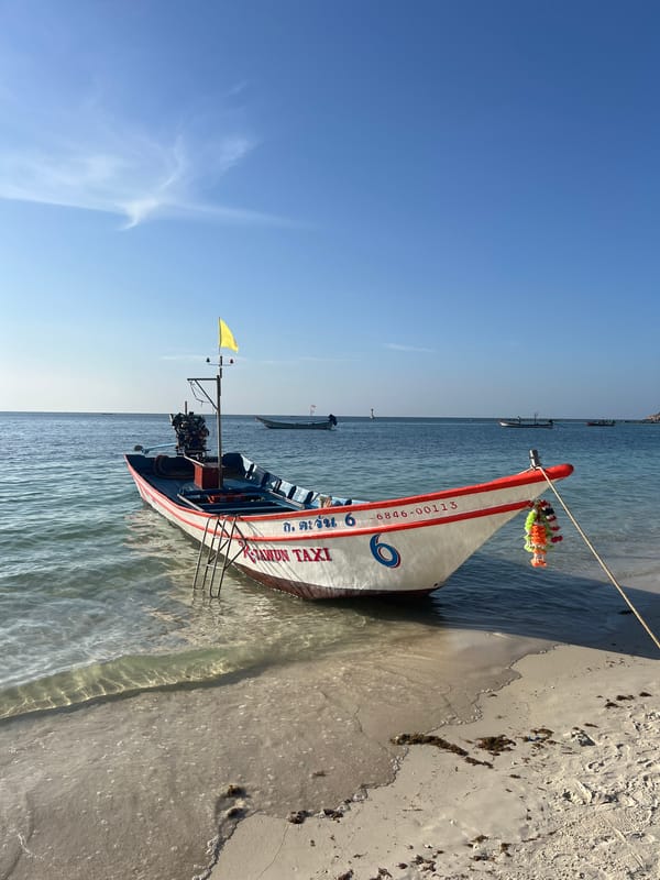 Longtail boats and calm waters on a Ko Pha-ngan beach