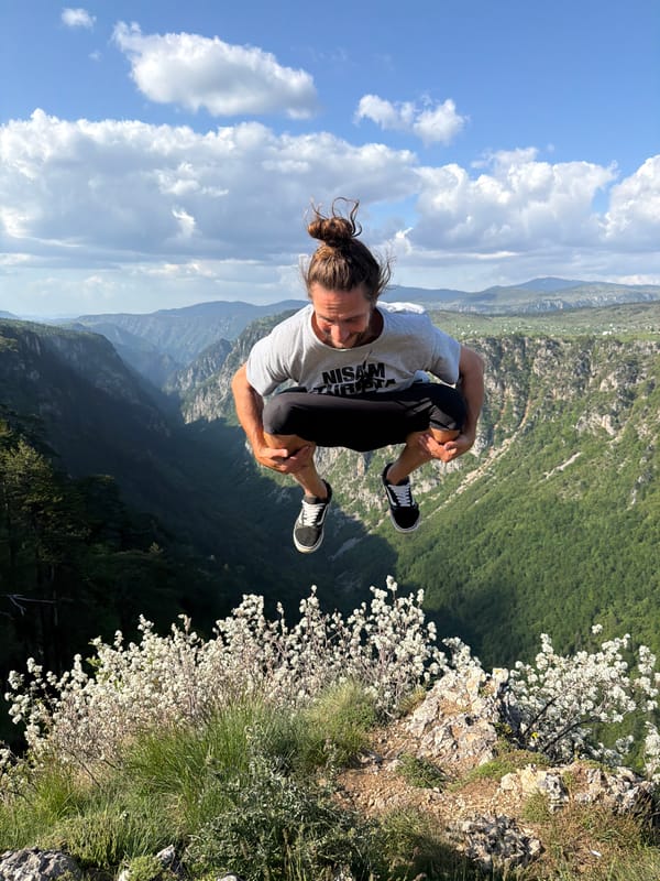 Tourist photographs scenic mountain cliffs in Nedajno, Montenegro