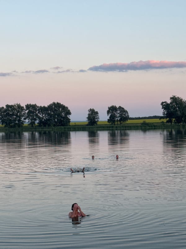Evening swim at a quiet lake as dusk settles in