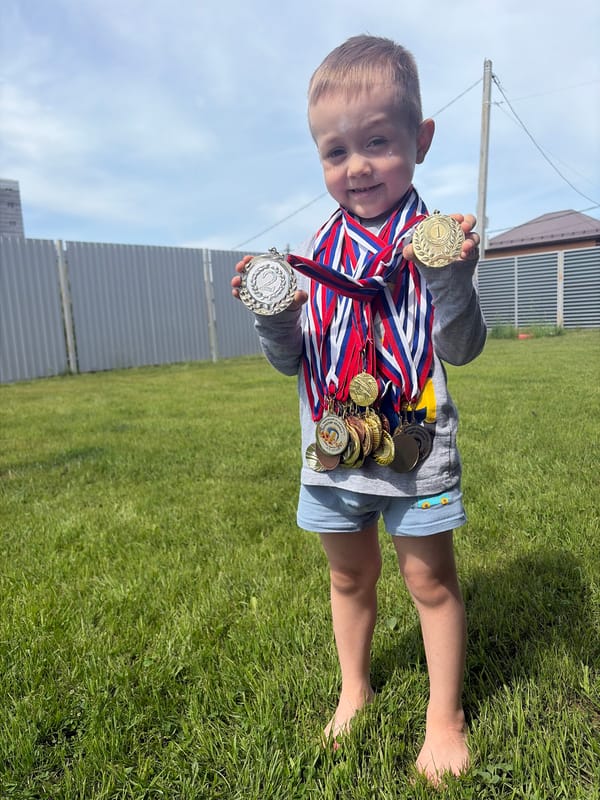 Child displays medal collection in Chaikovsky family gathering
