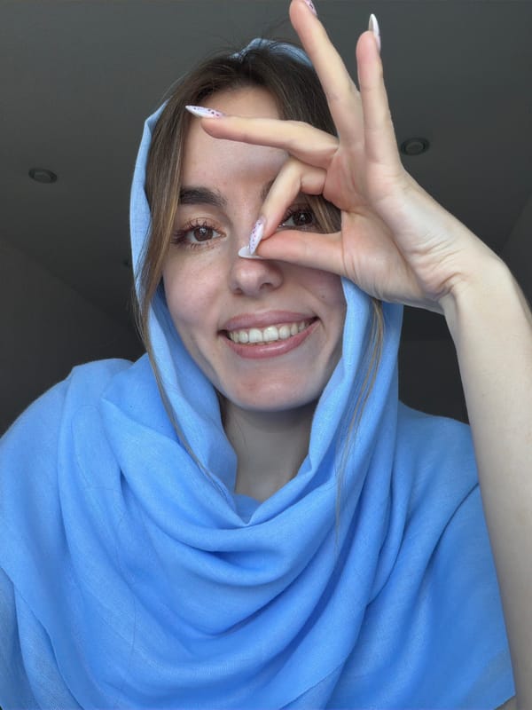 Woman in blue headscarf captured in morning moments, Sarapul