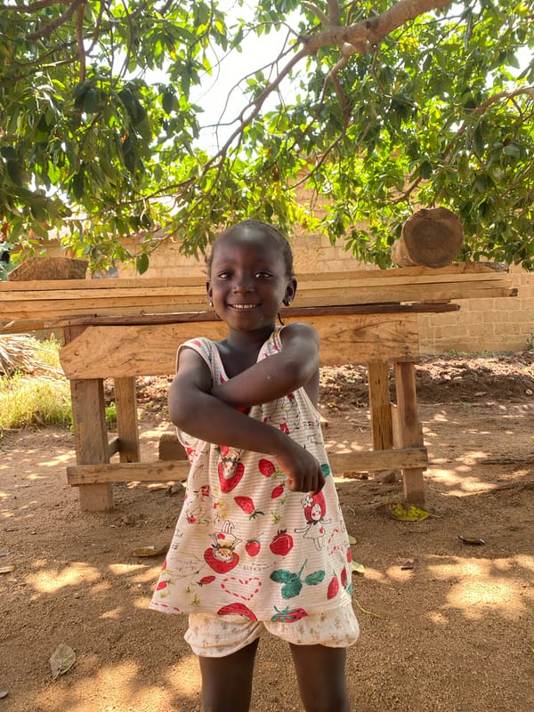 Children play and dance outdoors in Riyom, Nigeria