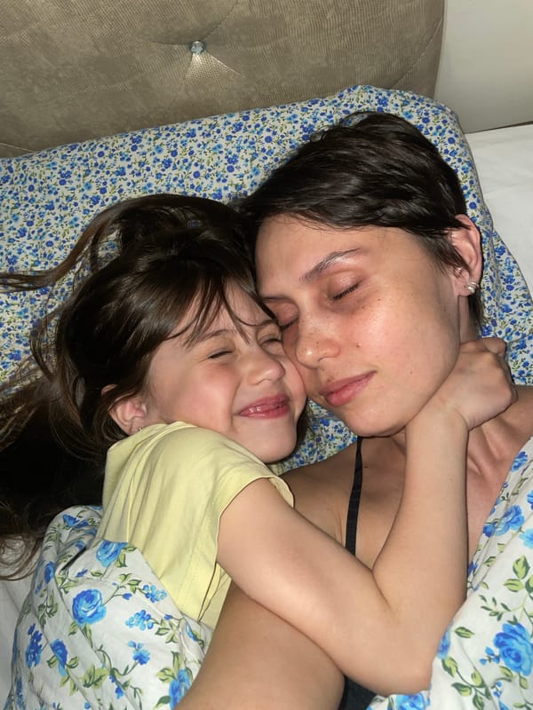 Mother and child share quiet moment on bed in Izhevsk