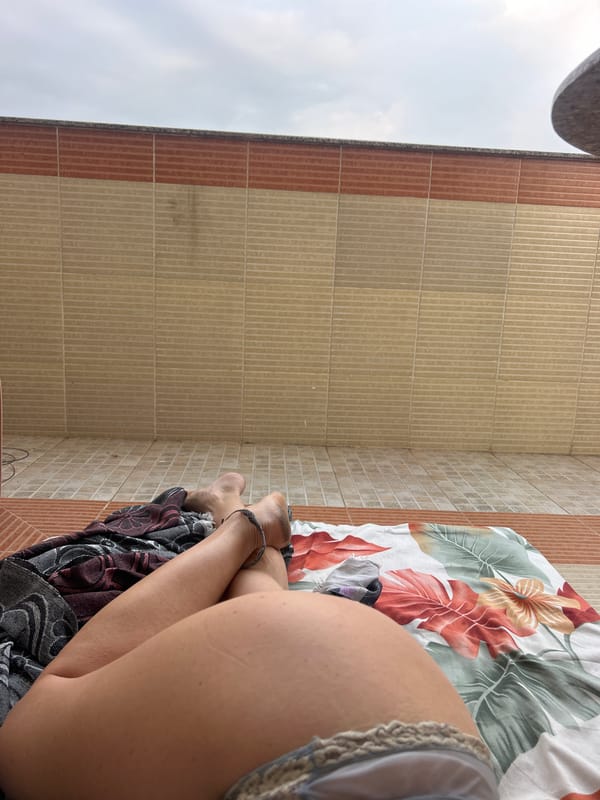 Person rests on floral surface in Puttaparthi