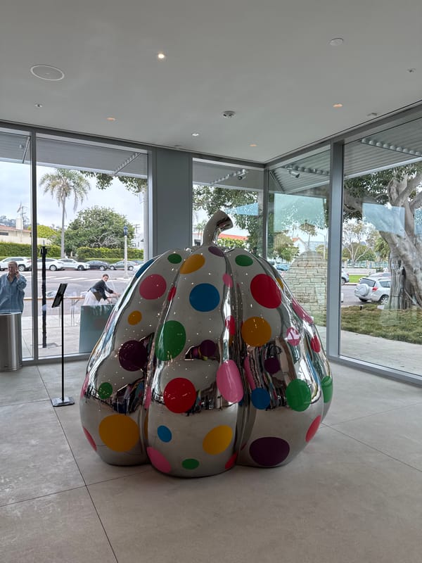 Woman and dachshund tour San Diego art museum evening