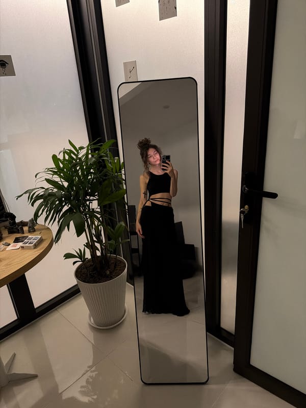 Person examines painting amid orange orbs in Đà Nẵng interior