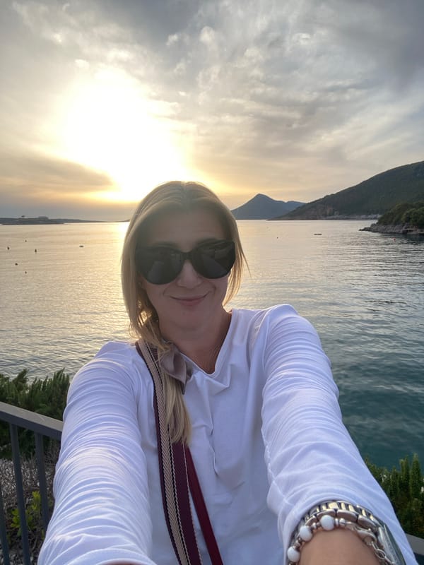 Women capture sunset selfies at Montenegro coastal viewpoint