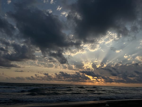 Stormy sunset light breaks through clouds over Supsa's Black Sea coast