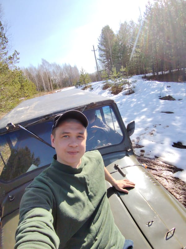 Man takes selfie on off-road vehicle in muddy Russian terrain