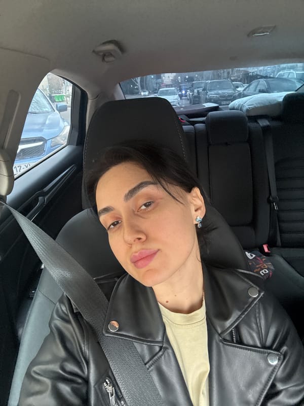 Woman takes selfie in passenger seat in Tbilisi