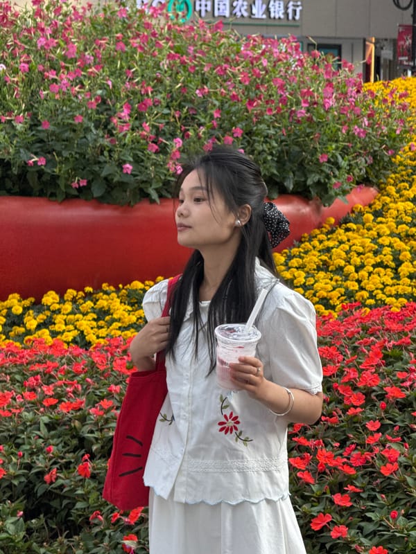 Tourists photograph spring flowers in downtown Chongqing district