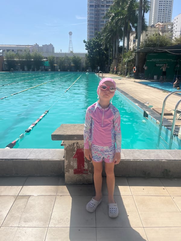 Children swim at Nha Trang pool complex during daylight hours