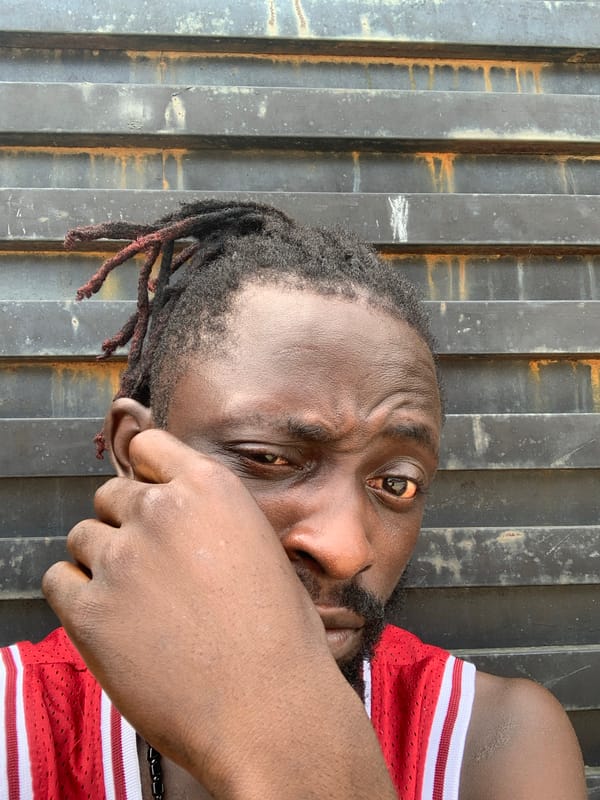 Young man in red athletic wear photographed in Lekki