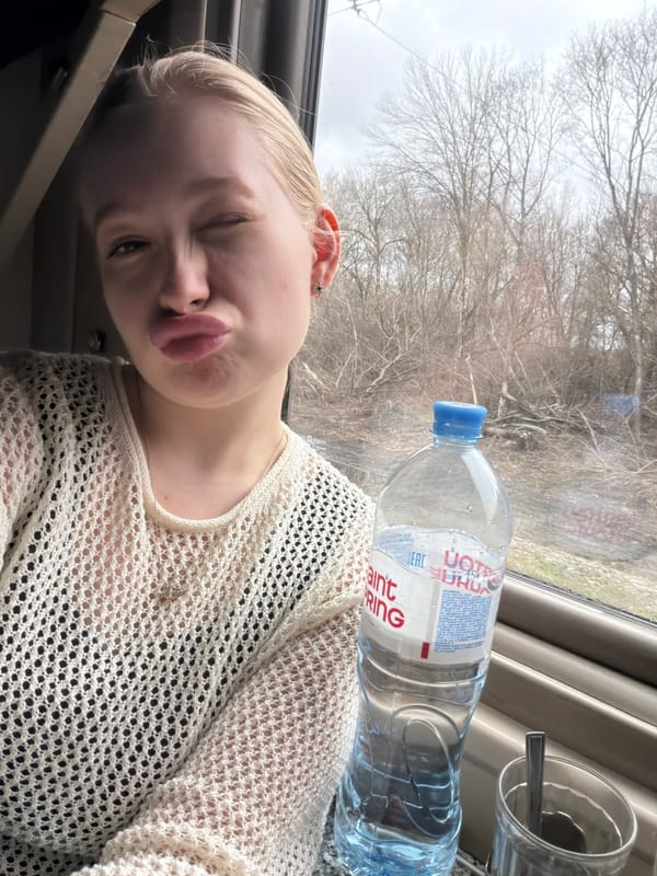 Woman poses playfully in train car in Russia