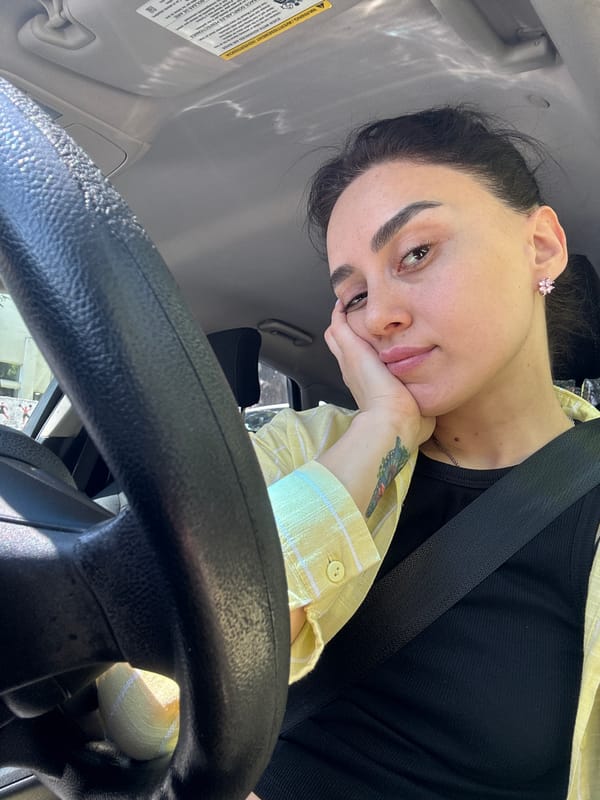 Woman photographed in car during morning hours in Tbilisi