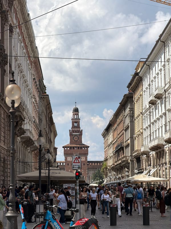 Milan street scene captures Sforza Castle tower view