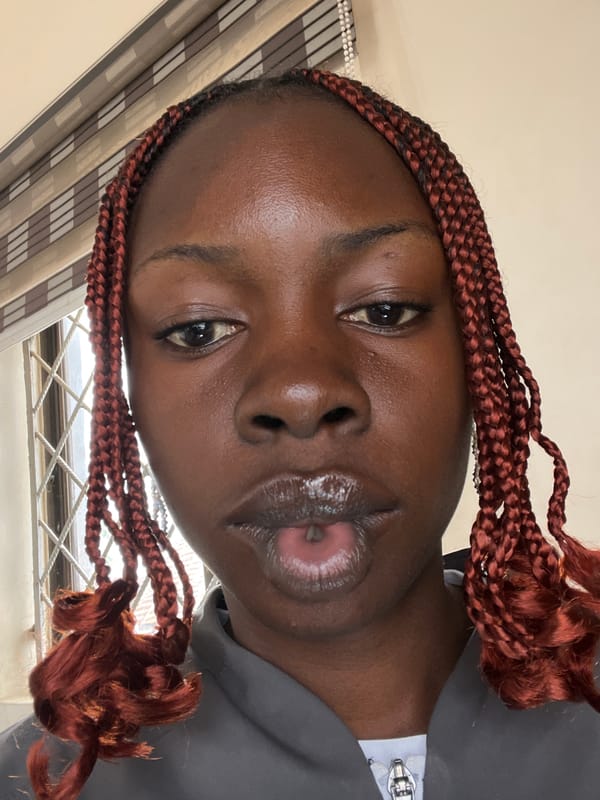 Selfie in Jos highlighting reddish-brown cornrow braids