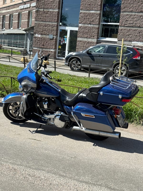 Harley-Davidson motorcycle parked on sunny street in Sinyavino, Russia