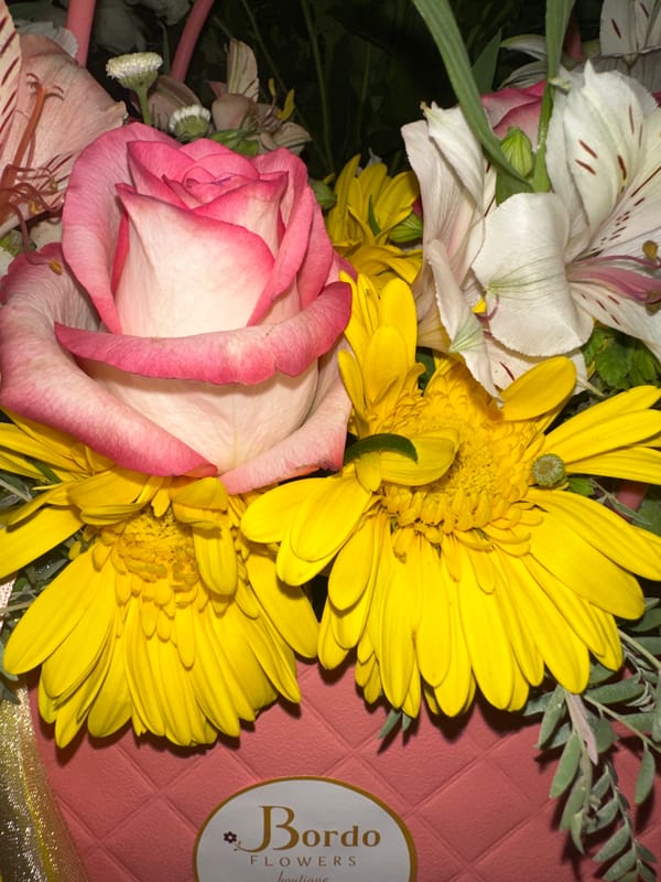 Flower bouquets and gift items fill an indoor gathering