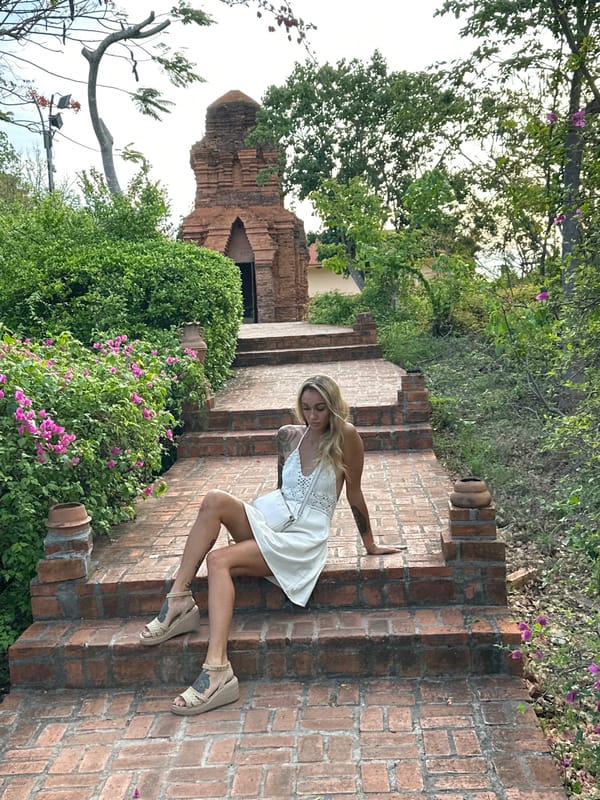 Tourist photographs at historic Cham towers in Vietnam