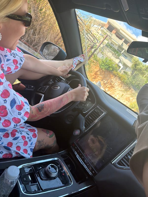 Woman relaxes in driver's seat in Montenegro vehicle