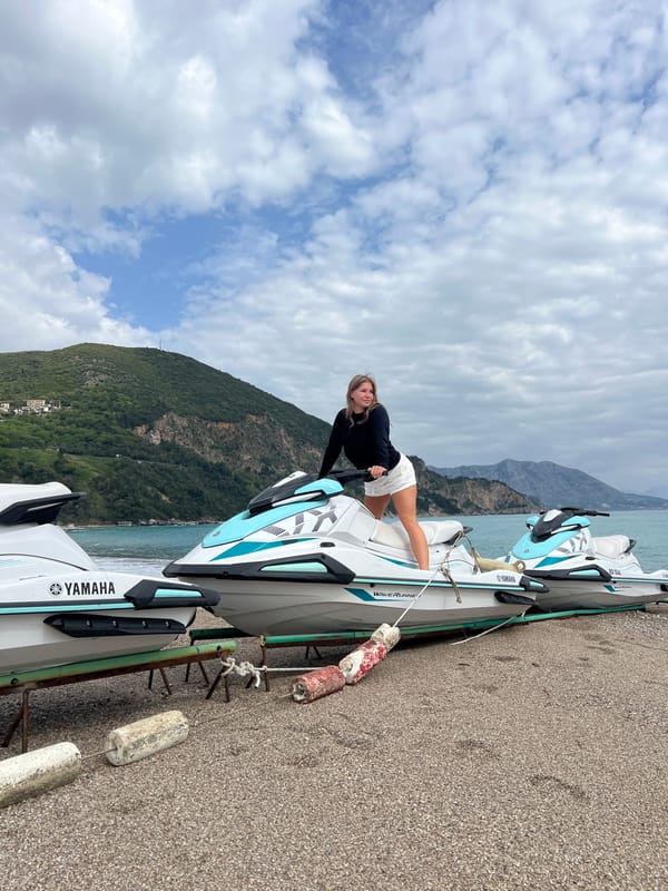 Woman poses with WaveRunner on Montenegro waterfront