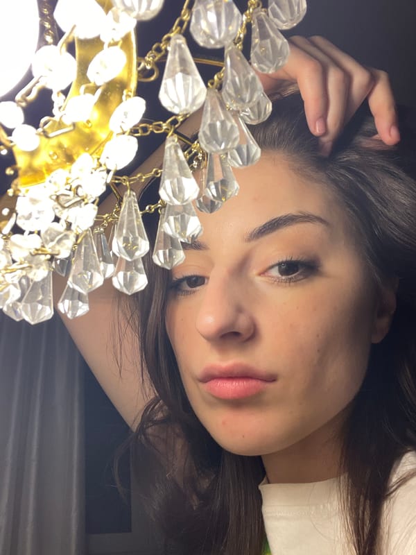 Woman photographed near chandelier in Moscow apartment setting